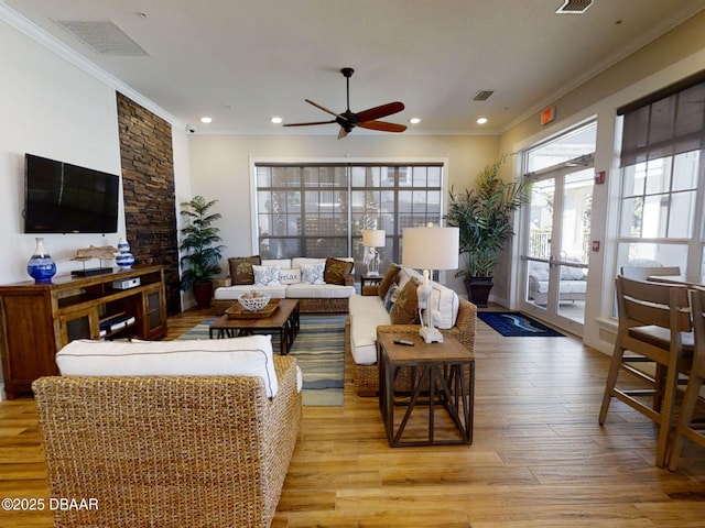 living room with ceiling fan, crown molding, french doors, and light wood-type flooring