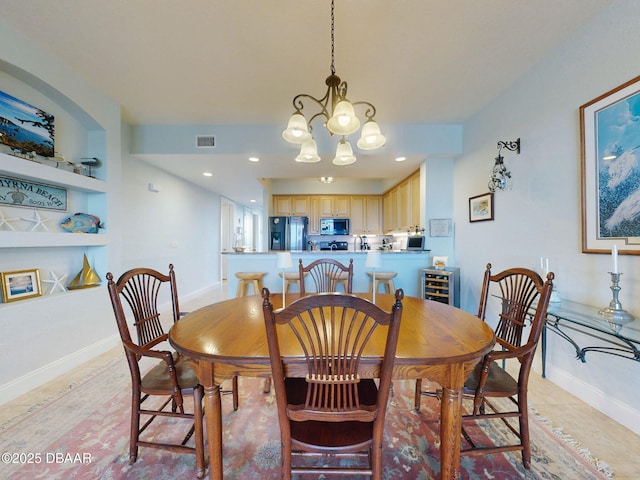 dining room featuring built in shelves, beverage cooler, and a notable chandelier