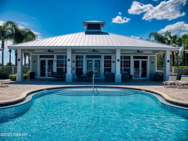 view of swimming pool with french doors, ceiling fan, and a patio area