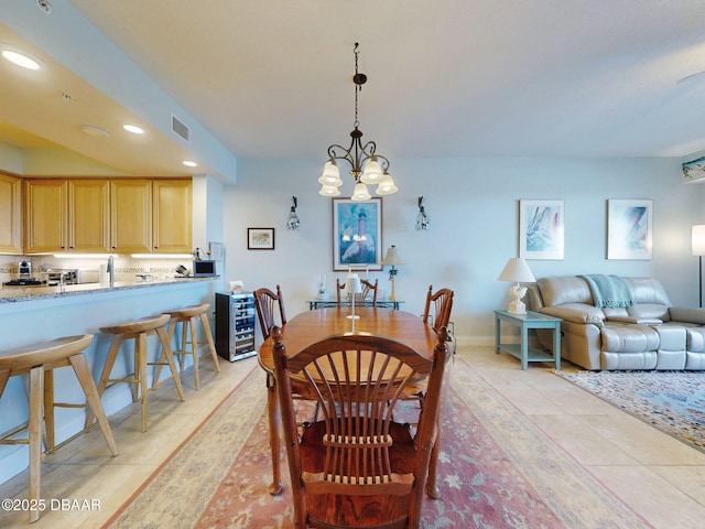 tiled dining room featuring an inviting chandelier