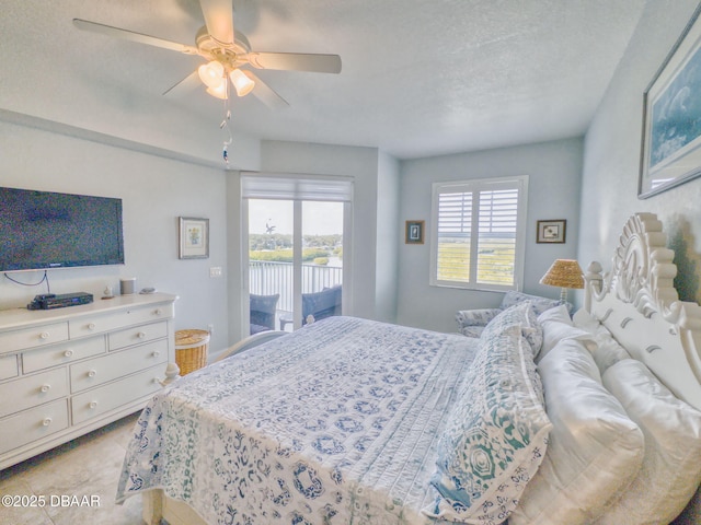 bedroom with multiple windows, a textured ceiling, access to outside, and ceiling fan