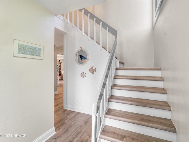 staircase with wood-type flooring