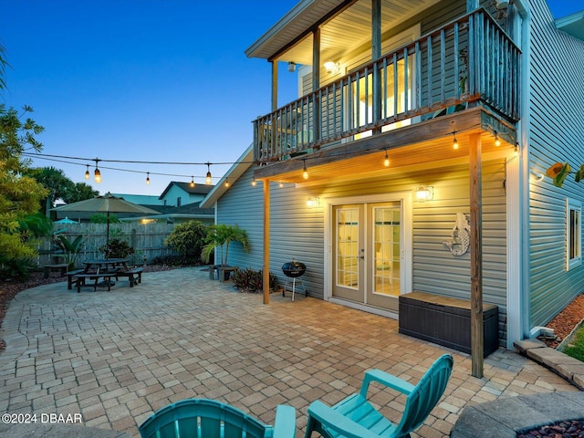 view of patio with french doors and a balcony