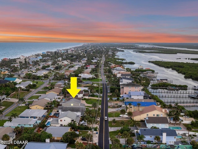 aerial view at dusk with a water view