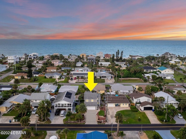 aerial view at dusk with a water view