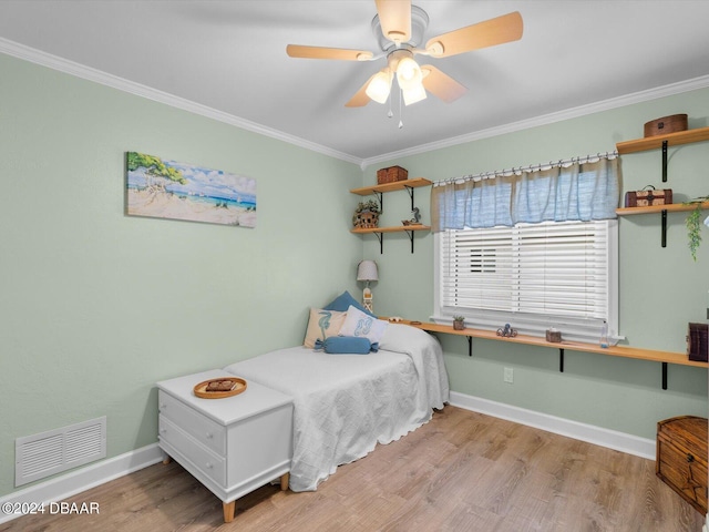 bedroom with ceiling fan, light wood-type flooring, and crown molding