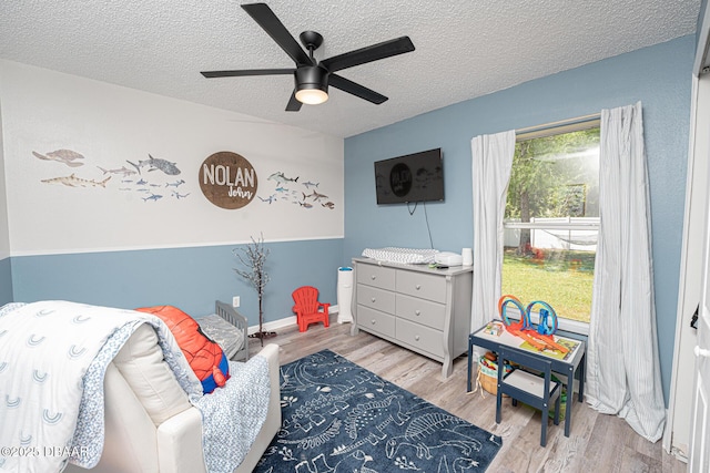 5 Zammer Ct, Palm Coast, FL 32164 - bedroom with a ceiling fan, a textured ceiling, and wood finished floors