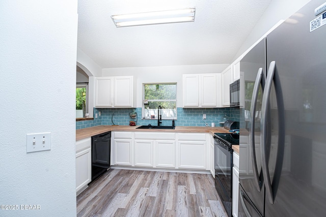 5 Zammer Ct, Palm Coast, FL 32164 - kitchen featuring butcher block countertops, decorative backsplash, a sink, and black appliances
