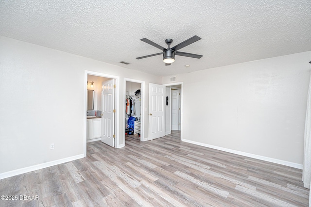 5 Zammer Ct, Palm Coast, FL 32164 - unfurnished bedroom featuring a walk in closet, visible vents, light wood-type flooring, baseboards, and a closet
