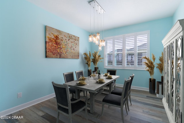 300 Blue Starfish Pl, Daytona Beach, FL 32124 - dining space with wood finished floors, a chandelier, and baseboards