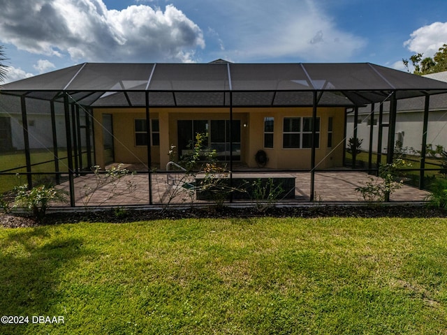 300 Blue Starfish Pl, Daytona Beach, FL 32124 - back of house with a lanai, a patio area, a lawn, and stucco siding