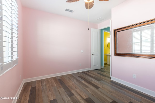 empty room with ceiling fan and dark hardwood / wood-style floors