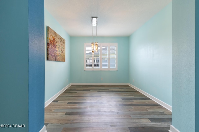 300 Blue Starfish Pl, Daytona Beach, FL 32124 - unfurnished room featuring a chandelier, wood finished floors, baseboards, and a textured wall