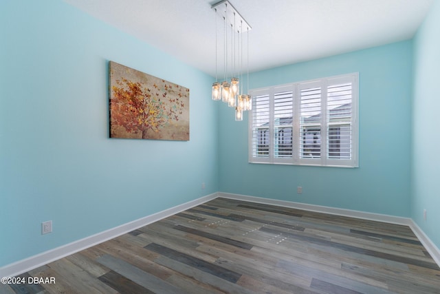 300 Blue Starfish Pl, Daytona Beach, FL 32124 - empty room with a chandelier, wood finished floors, and baseboards