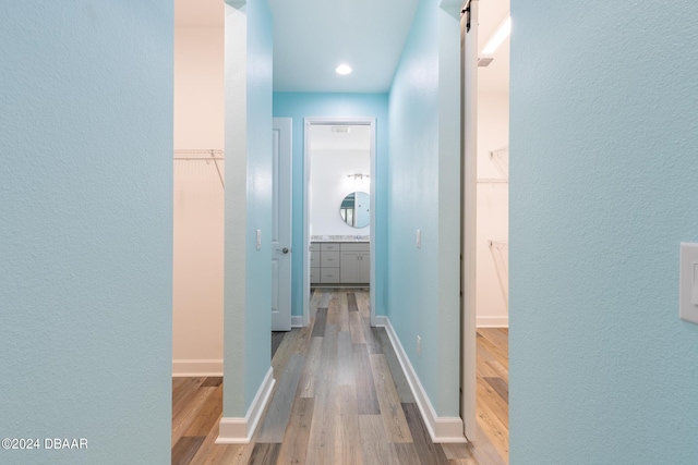 300 Blue Starfish Pl, Daytona Beach, FL 32124 - corridor featuring wood finished floors, baseboards, a barn door, and recessed lighting