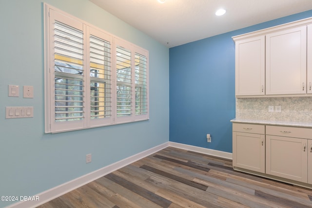 unfurnished dining area featuring dark hardwood / wood-style floors