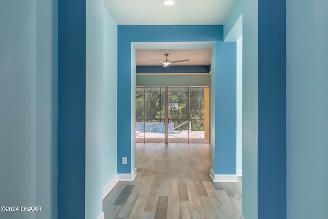 hallway with light hardwood / wood-style floors