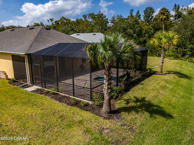 view of swimming pool with a lanai and a lawn