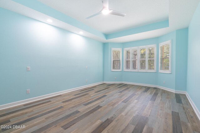 300 Blue Starfish Pl, Daytona Beach, FL 32124 - empty room featuring wood finished floors, baseboards, ceiling fan, recessed lighting, and a raised ceiling