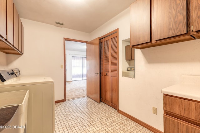 laundry room with separate washer and dryer, cabinet space, visible vents, and baseboards