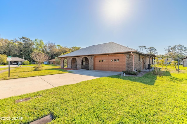 view of front of house featuring brick siding, an attached garage, concrete driveway, and a front lawn