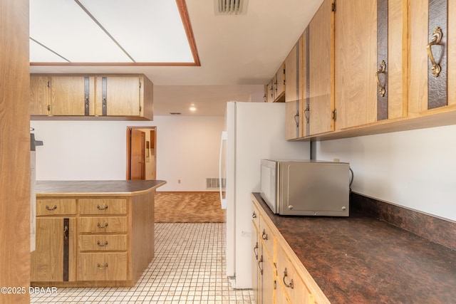 kitchen with dark countertops and visible vents