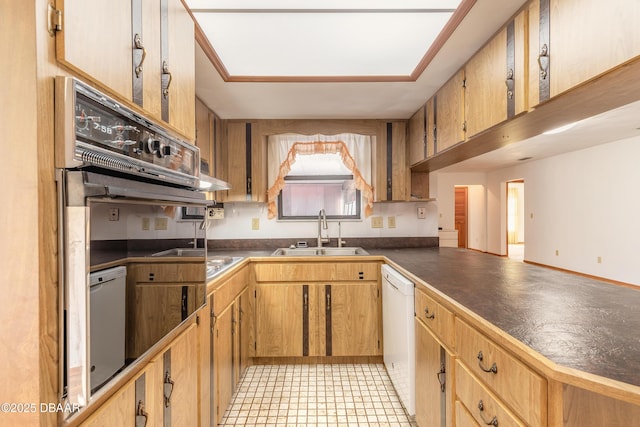 kitchen featuring a sink, dark countertops, and white dishwasher