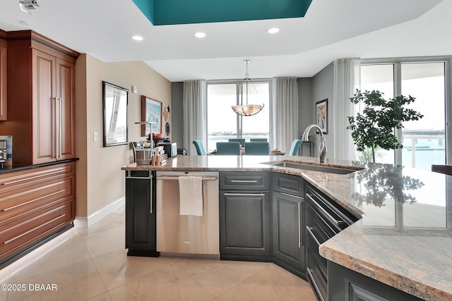231 Riverside Dr Unit 901, Holly Hill, FL 32117 - kitchen featuring dishwasher, a sink, healthy amount of natural light, recessed lighting, and light stone counters