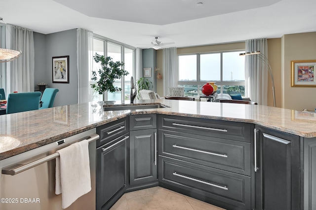 231 Riverside Dr Unit 901, Holly Hill, FL 32117 - kitchen with dishwasher, a sink, open floor plan, light stone counters, and light tile patterned floors