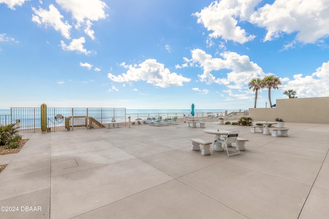 view of patio / terrace featuring a beach view and a water view