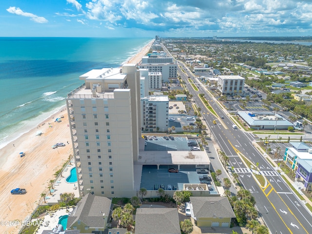 aerial view with a water view and a beach view