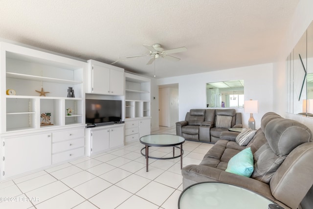 living room with a textured ceiling, ceiling fan, and light tile patterned floors