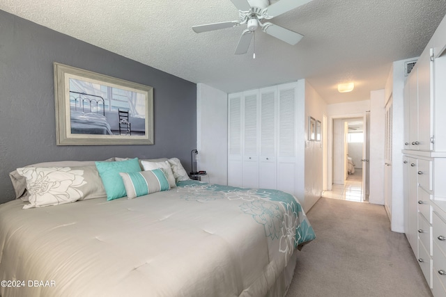 bedroom with a closet, a textured ceiling, light carpet, and ceiling fan