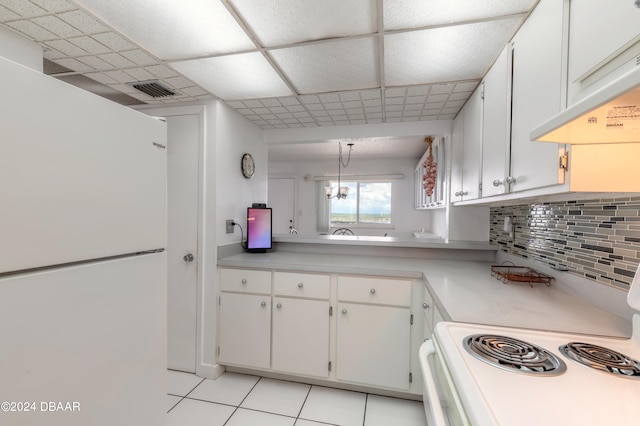 kitchen featuring decorative light fixtures, light tile patterned floors, tasteful backsplash, white cabinetry, and white appliances