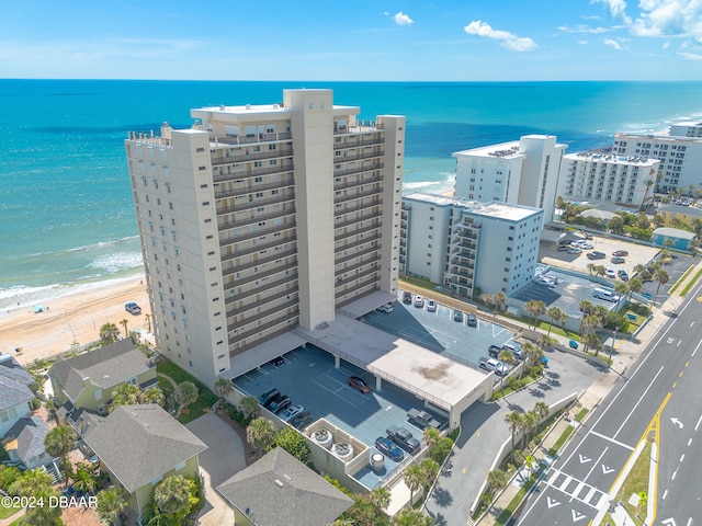 bird's eye view featuring a water view and a beach view