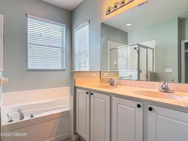 189 Perfect Dr, Daytona Beach, FL 32124 - bathroom with a garden tub, a stall shower, and double vanity