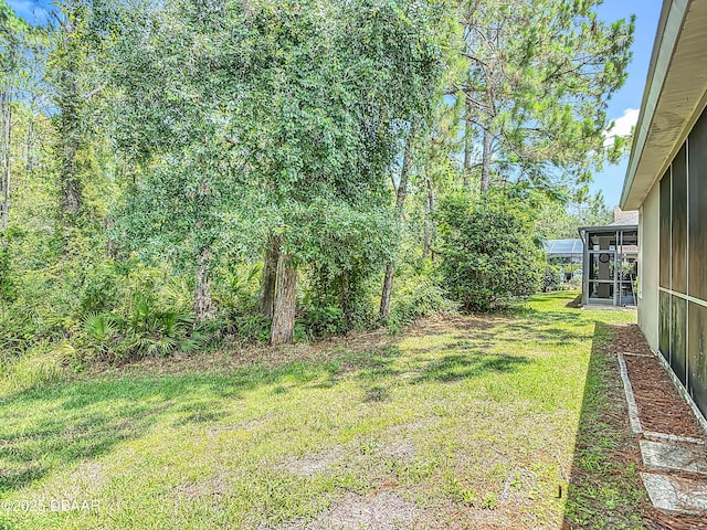 189 Perfect Dr, Daytona Beach, FL 32124 - view of grassy yard featuring a sunroom