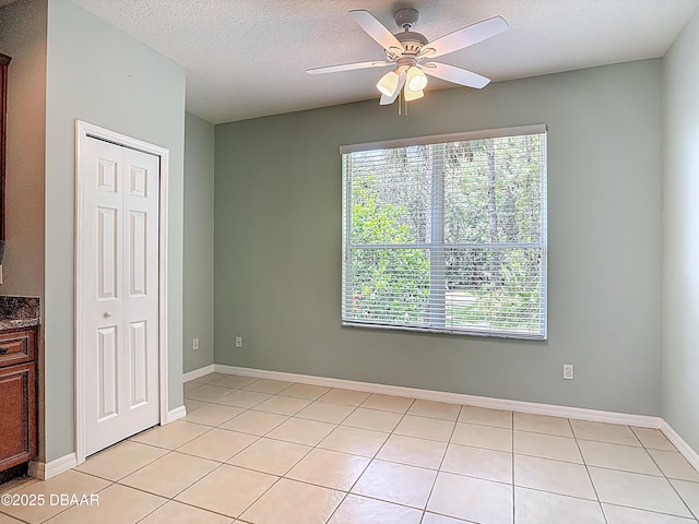 189 Perfect Dr, Daytona Beach, FL 32124 - empty room with ceiling fan, light tile patterned floors, and a textured ceiling