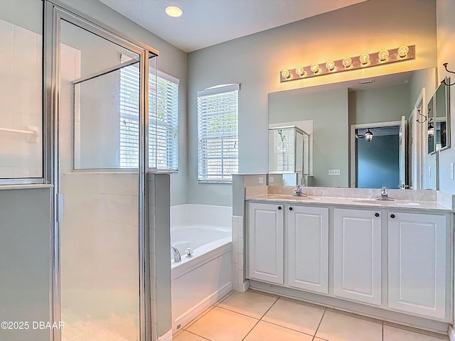189 Perfect Dr, Daytona Beach, FL 32124 - bathroom with a garden tub, a stall shower, double vanity, and tile patterned flooring