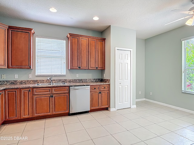 189 Perfect Dr, Daytona Beach, FL 32124 - kitchen featuring dishwasher, a ceiling fan, a textured ceiling, dark stone counters, and brown cabinetry