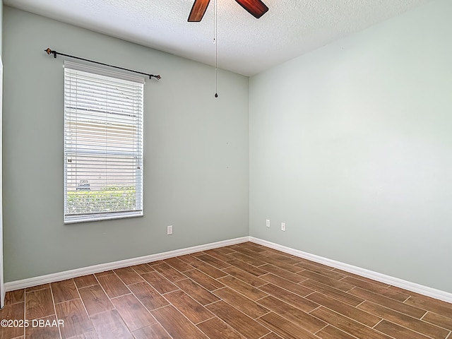 189 Perfect Dr, Daytona Beach, FL 32124 - spare room with dark wood-type flooring, ceiling fan, and a textured ceiling