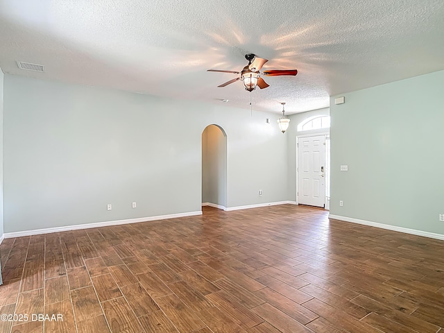 189 Perfect Dr, Daytona Beach, FL 32124 - spare room with a ceiling fan, wood finished floors, arched walkways, and a textured ceiling
