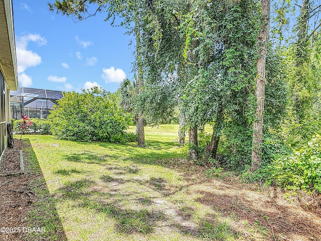 189 Perfect Dr, Daytona Beach, FL 32124 - view of green lawn with glass enclosure