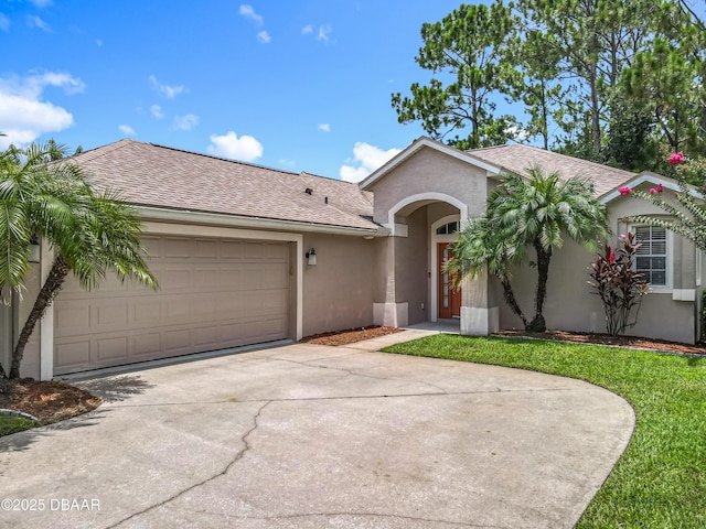 189 Perfect Dr, Daytona Beach, FL 32124 - ranch-style house with stucco siding, concrete driveway, roof with shingles, an attached garage, and a front yard