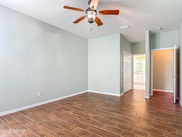 189 Perfect Dr, Daytona Beach, FL 32124 - unfurnished room with dark wood finished floors, ceiling fan, and a textured ceiling