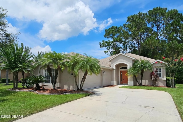 189 Perfect Dr, Daytona Beach, FL 32124 - view of front of property featuring stucco siding, concrete driveway, a front lawn, and a garage