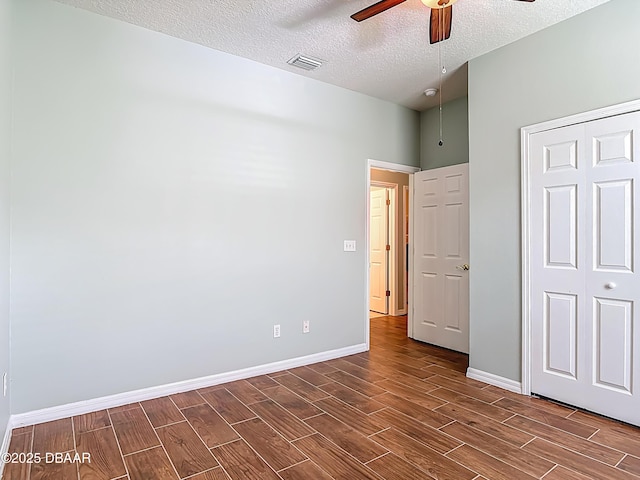 189 Perfect Dr, Daytona Beach, FL 32124 - unfurnished bedroom featuring wood finish floors, a textured ceiling, a closet, and a ceiling fan