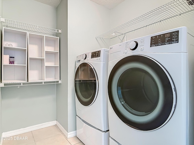 189 Perfect Dr, Daytona Beach, FL 32124 - laundry area with washing machine and clothes dryer and light tile patterned floors