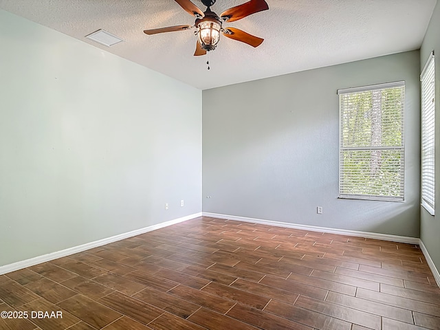 189 Perfect Dr, Daytona Beach, FL 32124 - unfurnished room featuring a ceiling fan, dark wood-style flooring, and a textured ceiling