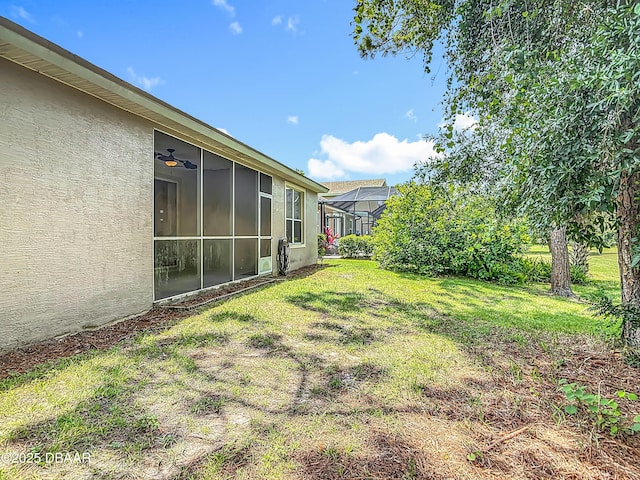 189 Perfect Dr, Daytona Beach, FL 32124 - view of grassy yard with glass enclosure